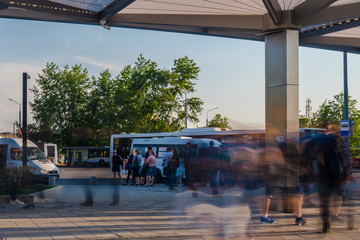 passengers waiting and boarding buses at the bus terminal