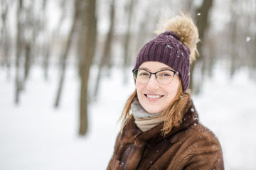Fototapeta na wymiar Portrait of young woman during walk at winter