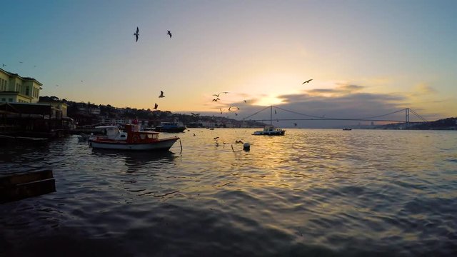 bosphorus sun down with bridge and boat in istanbul