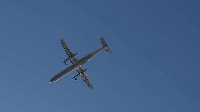 Business turboprop plane flies overhead.