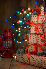 New Year's gifts with red ribbon. Packing Christmas gifts. Garland with lights. New Year.