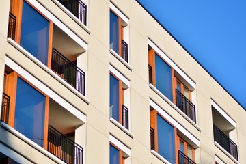 Modern apartment buildings on a sunny day with a blue sky. Facade of a modern apartment building
