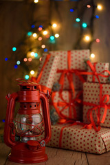 New Year's gifts with red ribbon. Packing Christmas gifts. Garland with lights. New Year.