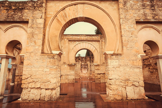 Arches of 10th century ruined palace in Moorish medieval city Medina Azahara in Andalucia region, Spain. UNESCO world heritage site