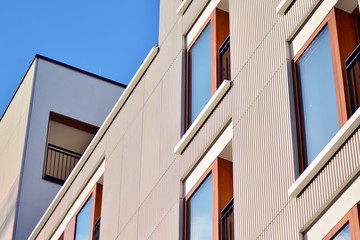 Modern apartment buildings on a sunny day with a blue sky. Facade of a modern apartment building