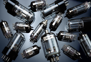 Electronic vacuum tubes on the dark mirror background. Old electronic radio components.