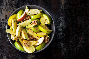 Dietary vegan apple salad with seeds and spices. Nutritious fitness salad with apples and spices.