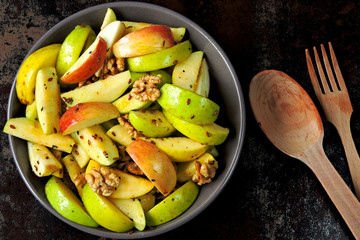 Dietary vegan apple salad with seeds and spices. Nutritious fitness salad with apples and spices.