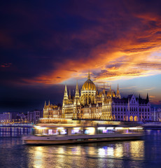 Parliament building of Budapest above Danube river in Hungary at night.