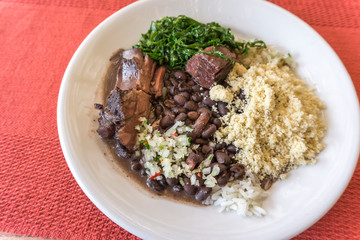 White dish with ingredients of feijoada, typical food of Brazil