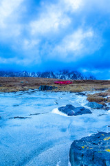 Lonely Red Fishing Boat At Skagsanden Beach in Norwegian Snowy Slope