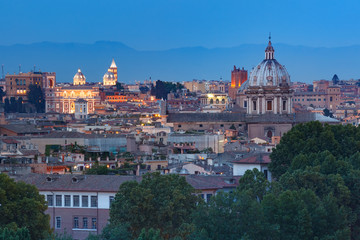 Fototapeta premium Aerial wonderful view of Rome with roofs and churches at sunset time in Rome, Italy