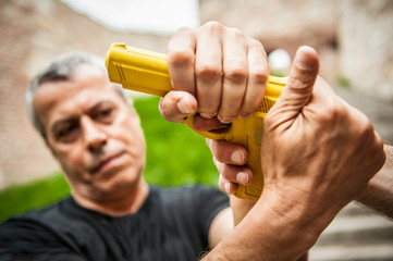 Gun point. Kapap instructor demonstrates self defense techniques against threat