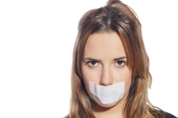 Blonde woman silenced with tape, removing it and finally free. Isolated, over a white background.