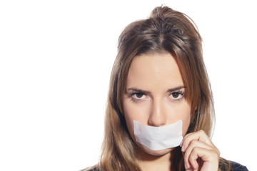 Blonde woman silenced with tape, removing it and finally free. Isolated, over a white background.