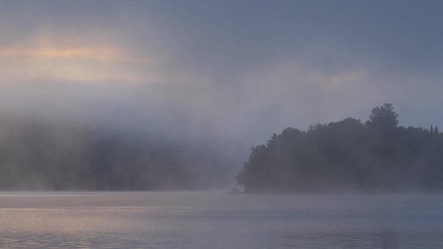 Misty morning on Eagle lake, Haliburton, Ontario, Canada.