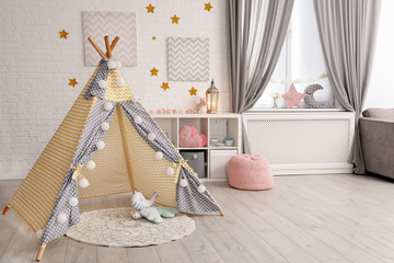 Fototapeta na wymiar Cozy kids room interior with play tent and toys