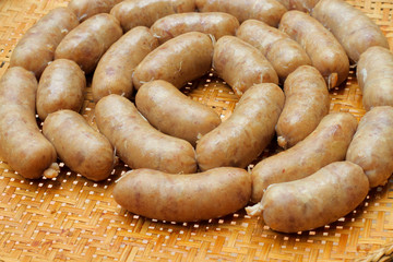 raw homemade sausage on a wooden board