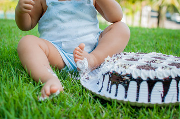 baby smashing  a cake