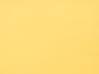 Texture of yellow colored paper. Can be used as a background