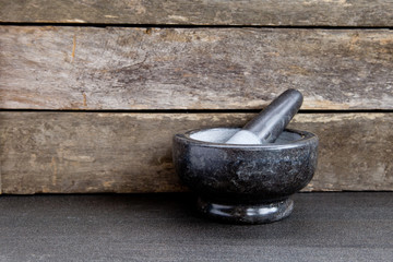 Gray / Grey Marble Mortar and Pestle on slate with rustic wooden background