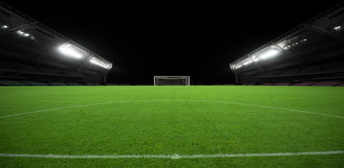 Fototapeta na wymiar A neat football stadium built under night lights