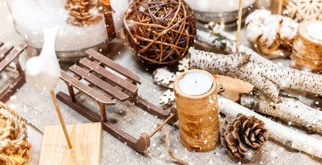 Christmas table place setting with christmas pine cones, wooden decorations, bokeh, snowflakes. Xmas and Happy New Year theme, selective focus