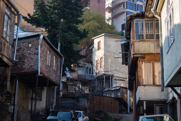 Suburbs - old historical and touristic part of Tbilisi city. Exploring, traveling, walking, wondering. Old Georgian wooden traditional balconies in Vake district. Street and roofs