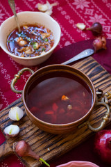 Happy Christmas food. Hot traditional beetroot, cabbage red soup - borsch for lunch or dinner. Red New Year background. Vegan and vegetarian
