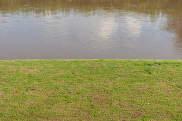Green lawn near river