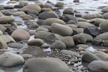  Big smooth black beach stones in the water
