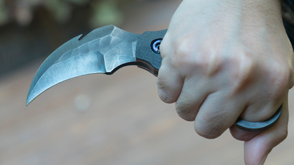 Knife in the hands, karambit knife tactical fighter, self defense Martial Arts Fighting