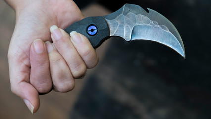Knife in the hands, karambit knife tactical fighter, self defense Martial Arts Fighting