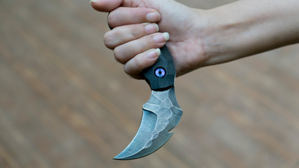 Knife in the hands, karambit knife tactical fighter, self defense Martial Arts Fighting