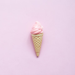 Pink meringue on ice cream cone on pink background