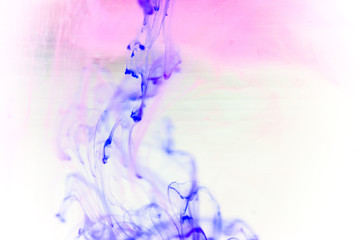 a drop of paint pouring in water