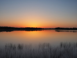 Fototapeta na wymiar Sunrise on a perfectly calm Nine Mile Pond in Everglades National Park, Florida.