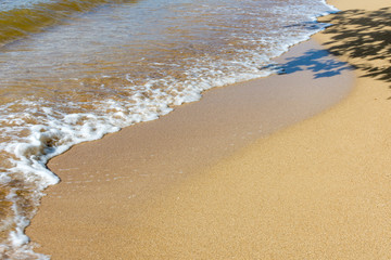 waves brush sands at beach