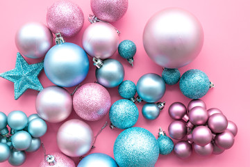 Christmas and New Year symbols. Toys for festive tree. Blue and pink balls and stars on pink background top view