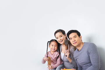 Portrait happy Asian family with kitchen equipment utensil over white background