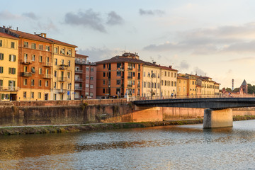 Fototapeta premium View on embankment of Arno river and Solferino bridge at sunset. Pisa, Italy