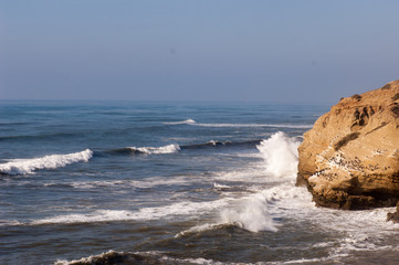 wave hitting rocks in southern california