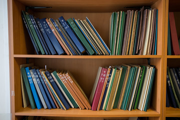 blurred Image many old books on bookshelf in library