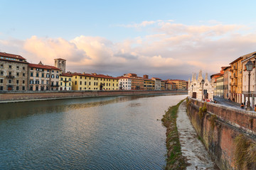 Obraz premium View on embankment of Arno river with Church of Santa Maria de la Spina at sunset. Pisa, Italy