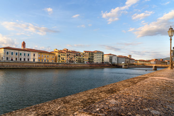 Fototapeta na wymiar View on embankment of Arno river and Solferino bridge. Pisa, Italy