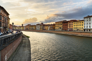 View on embankment of Arno river at sunset. Pisa, Italy