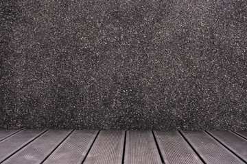 Black wooden flooring and dark gray terrazzo background with copy and product placement space