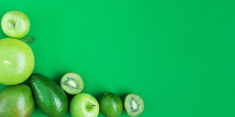 Creative background of green various summer tropical fruits. Food concept for fitness dinner,plant based diet,frutarian,healthy eating