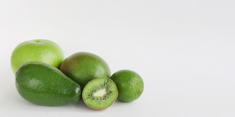 Creative background of green various summer tropical fruits. Food concept for fitness dinner,plant based diet,frutarian,healthy eating