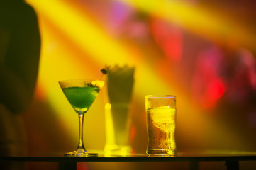 drink glasses on the table with lighting party background